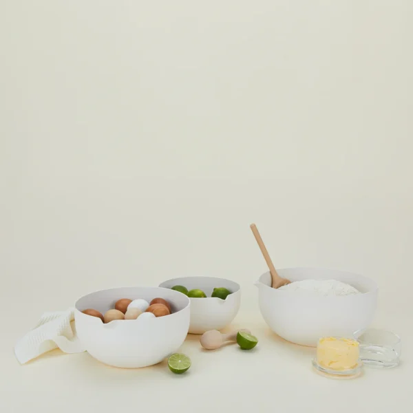 Essential Mixing Bowls Ivory with lime, butter and kitchen towel on the side.